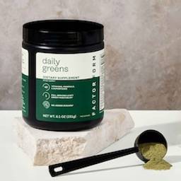 Daily Greens jar with scoop and greens powder