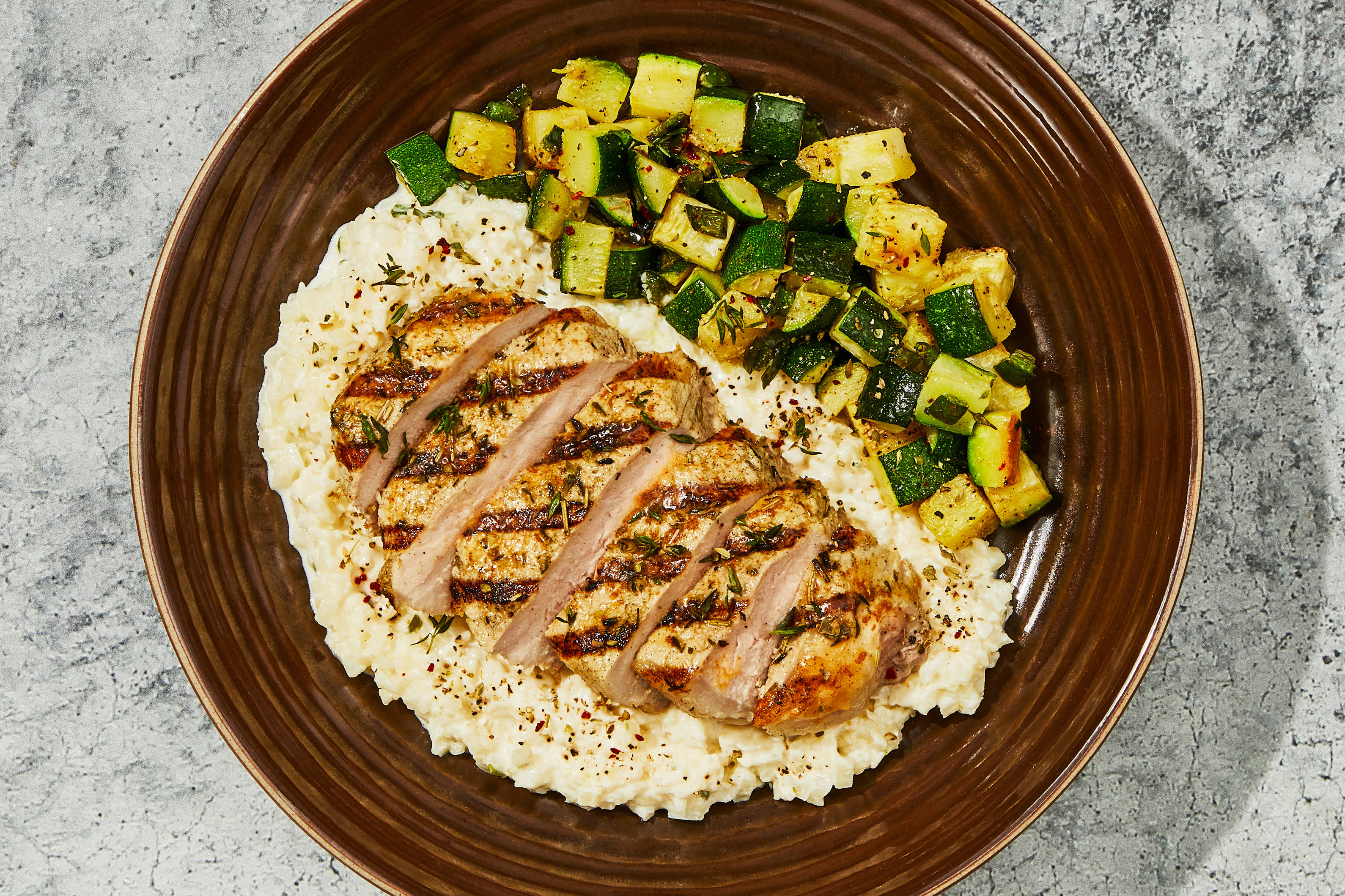 Grilled Pork Chop & Smoked Cheddar Cauli Grits