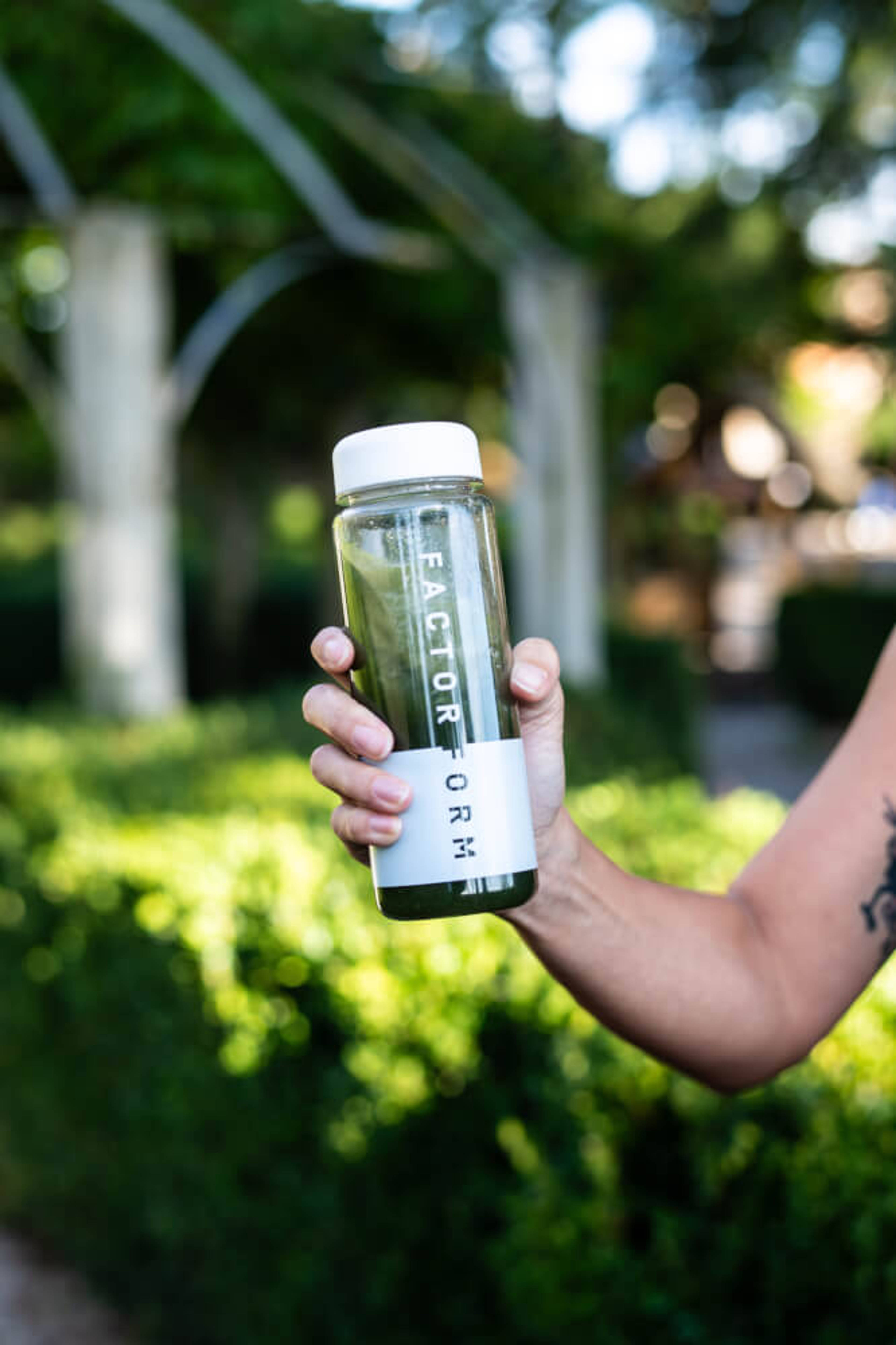 Lifestyle image of person shaking a Factor Form bottle