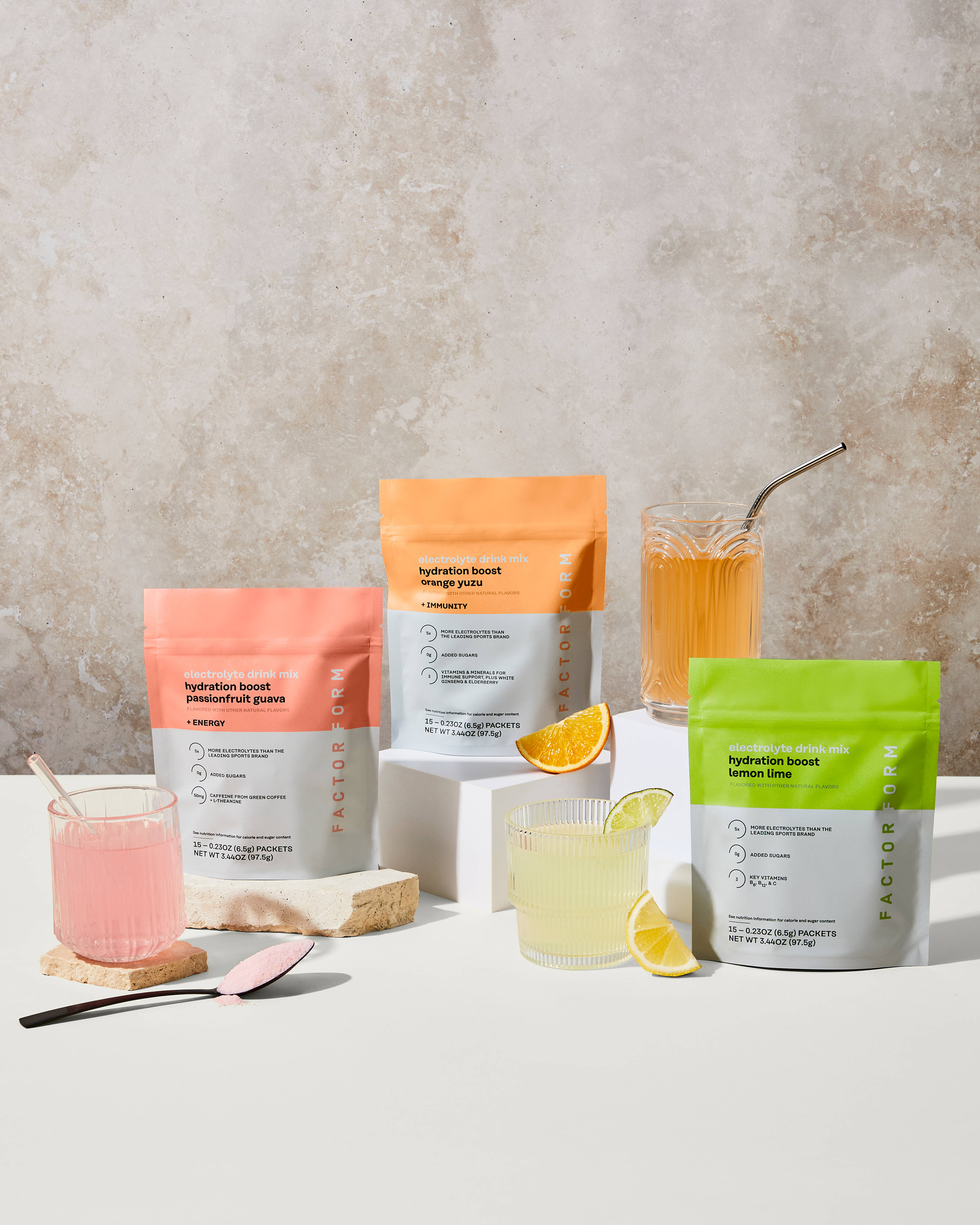 Hydration Boost electrolyte drink mix packaging and powders, Passionfruit Guava, Orange Yuzu, and Lemon Lime flavors